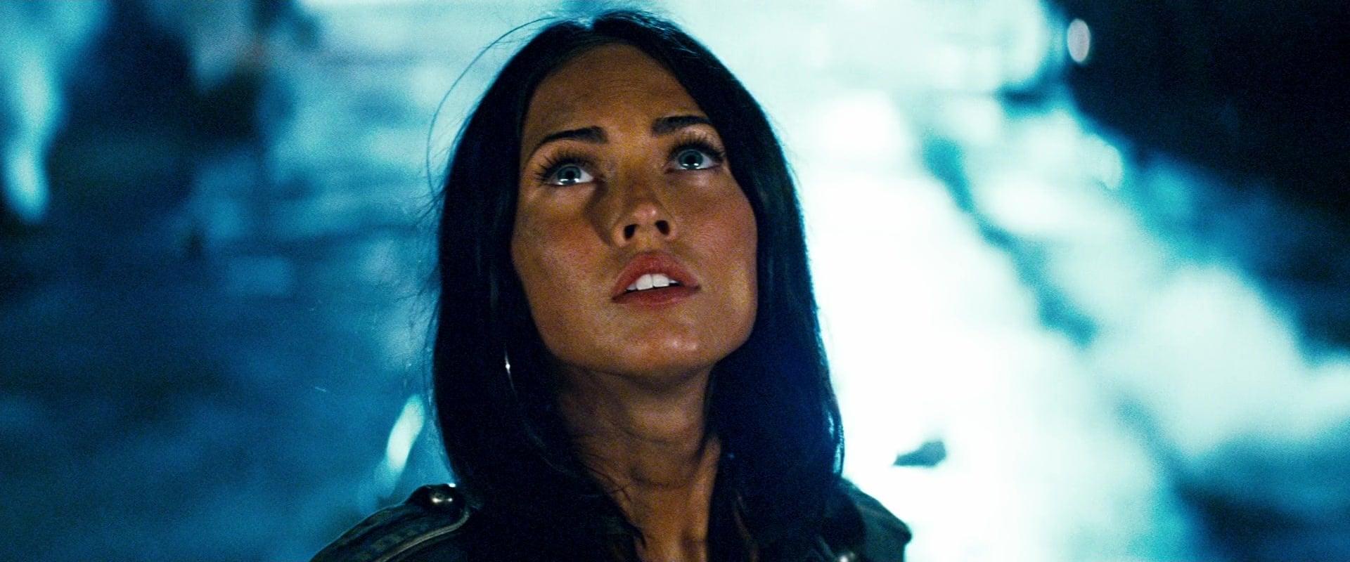 Mikaela Banes (Megan Fox) comes face-to-face with Optimus Prime (Peter Cullen) in Transformers (2007), Paramount Pictures