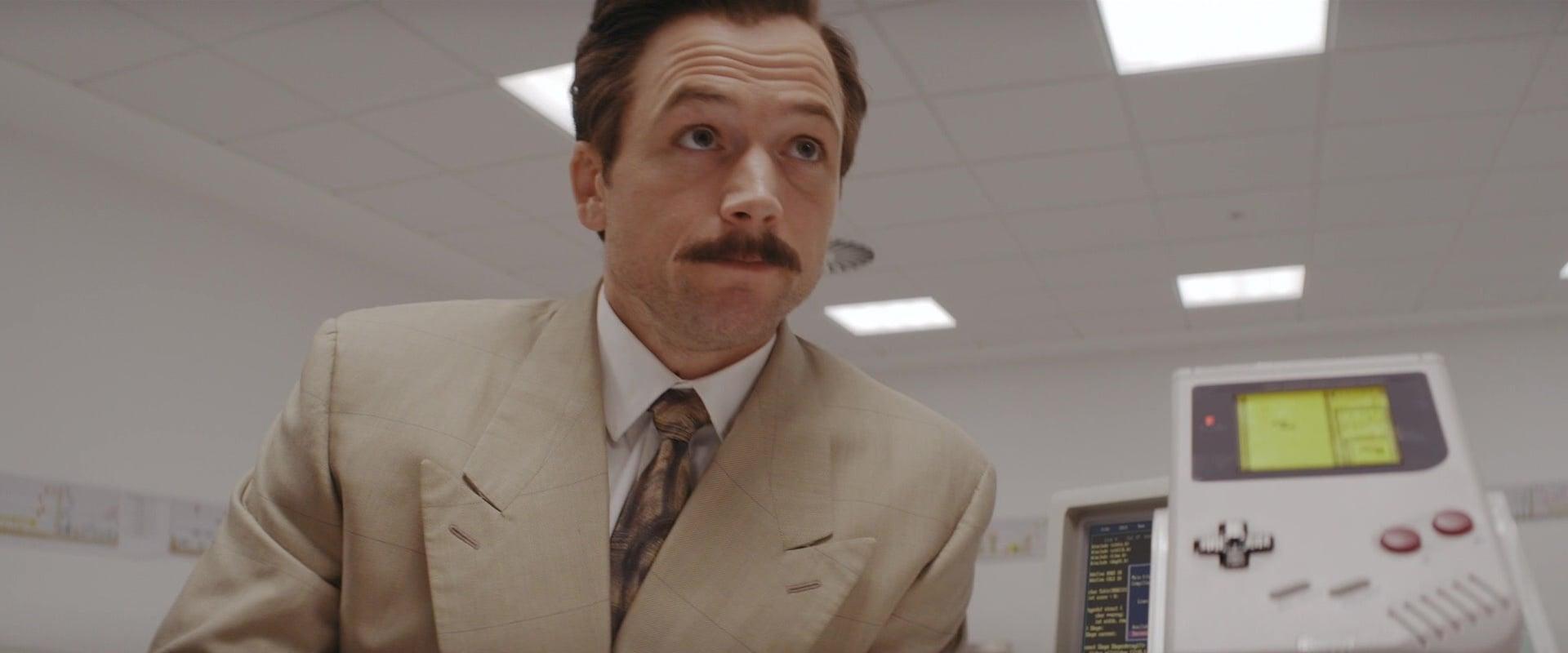 Henk Rogers (Taron Egerton) is first introduced to the Nintendo Game Boy in Tetris (2023), Apple Studios