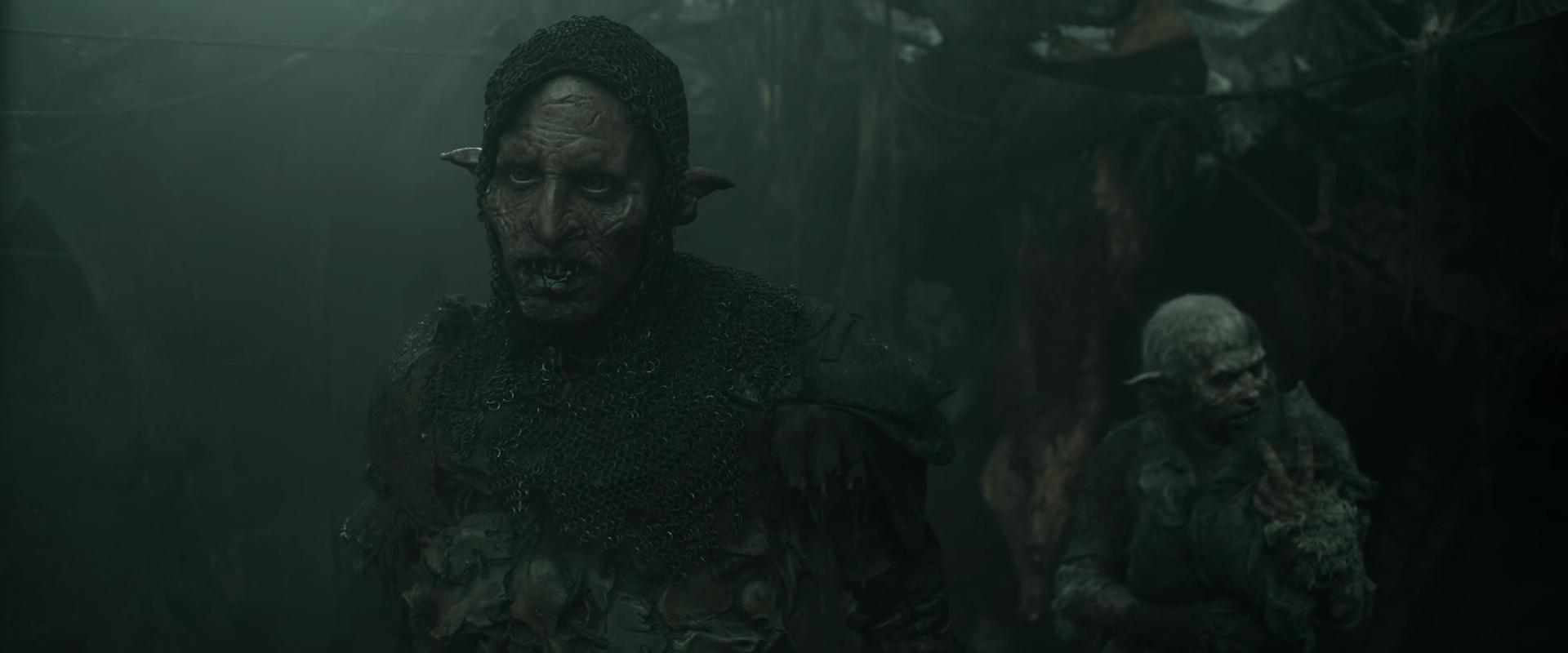 Glüg (Robert Strange) reluctantly accepts Adar's (Joseph Mawle) orders in The Lord of The Rings: The Rings of Power Season 2 Episode 3 " The Eagle and The Sceptre" (2024), Amazon Prime