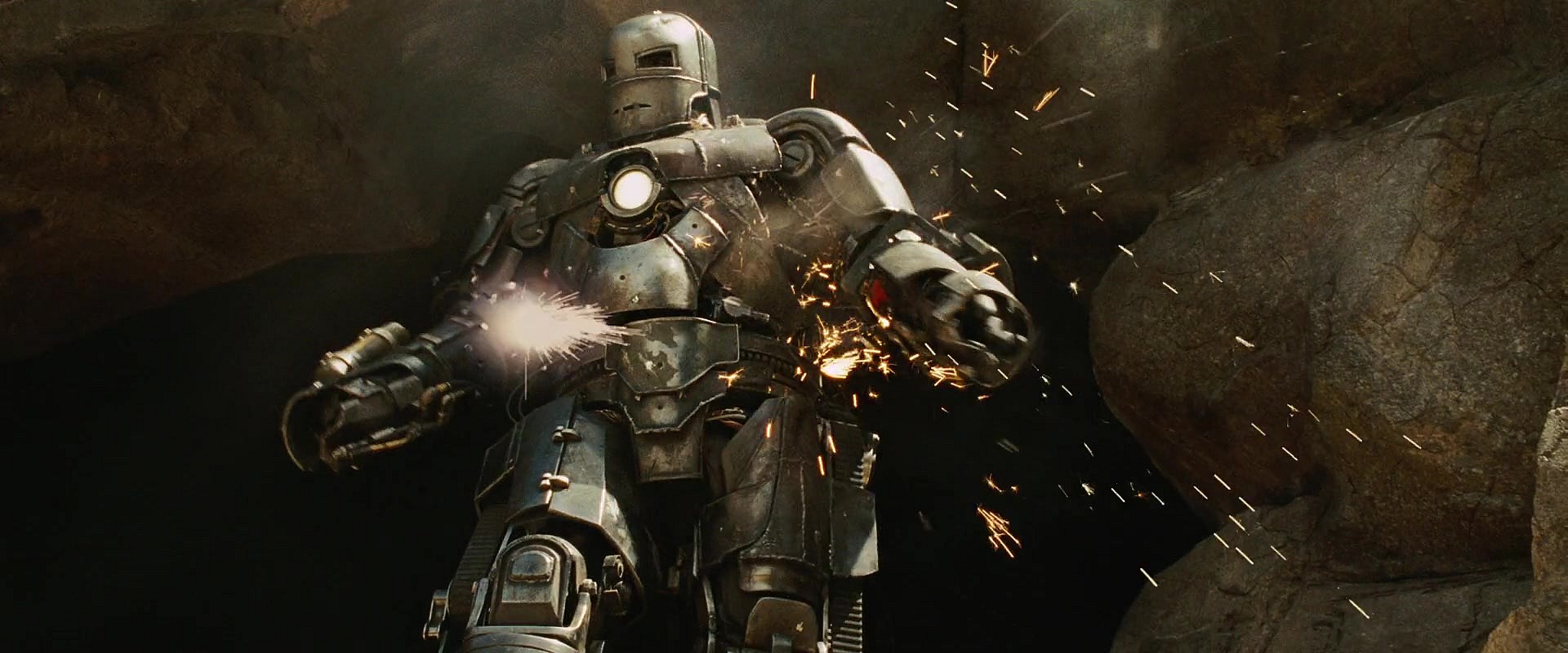 Tony Stark (Robert Downey Jr.) emerges from his cave after making use of a box of scraps in Iron Man (2008), Marvel Entertainment