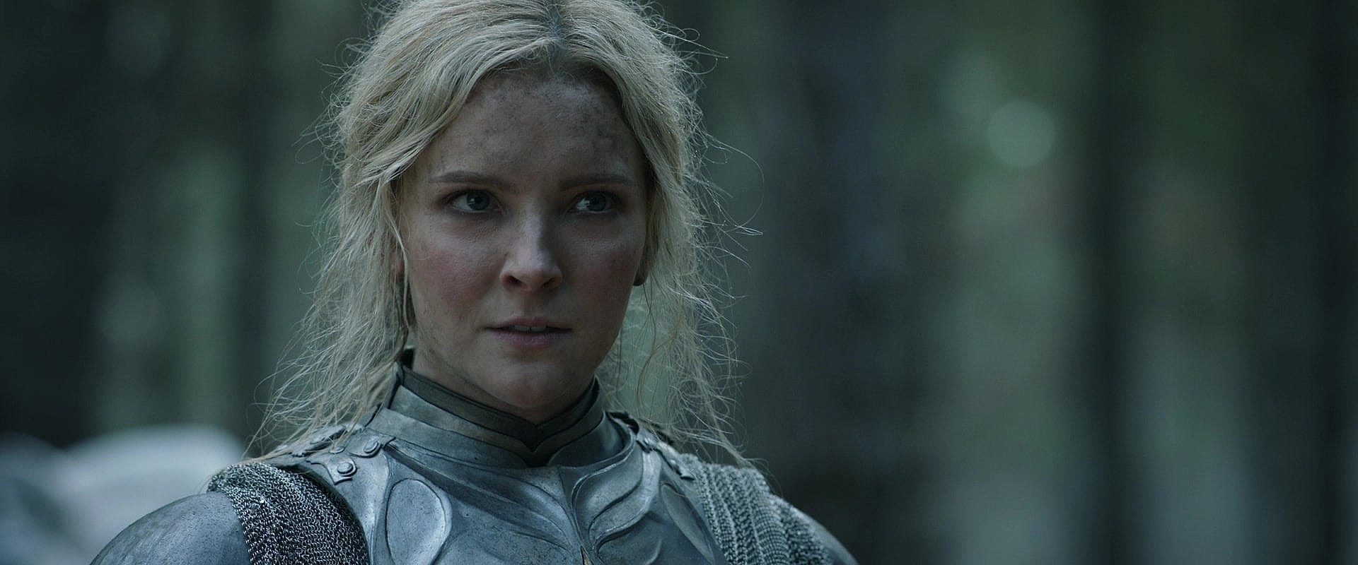 Galadriel (Morfydd Clark) attempts to stop Halbrand (Charlie Vickers) from killing the felled Adar (Joseph Mawle) in The Lord of the Rings: The Rings of Power Season 1 Episode 6 "Udûn" (2022), Amazon Studios