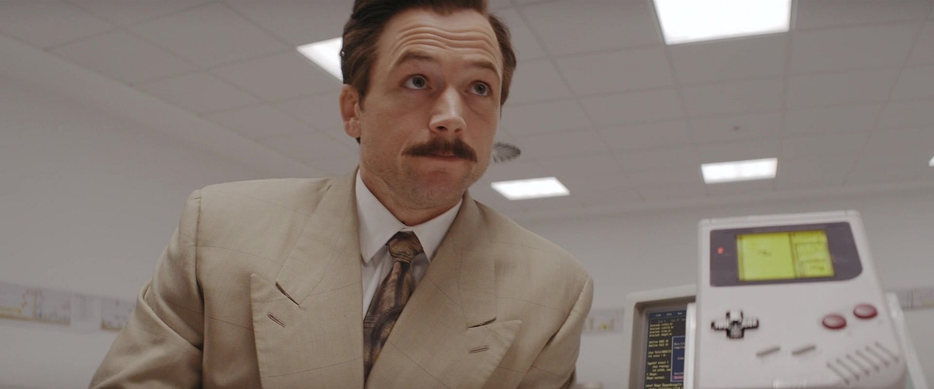 Henk Rogers (Taron Egerton) is first introduced to the Nintendo Game Boy in Tetris (2023), Apple Studios