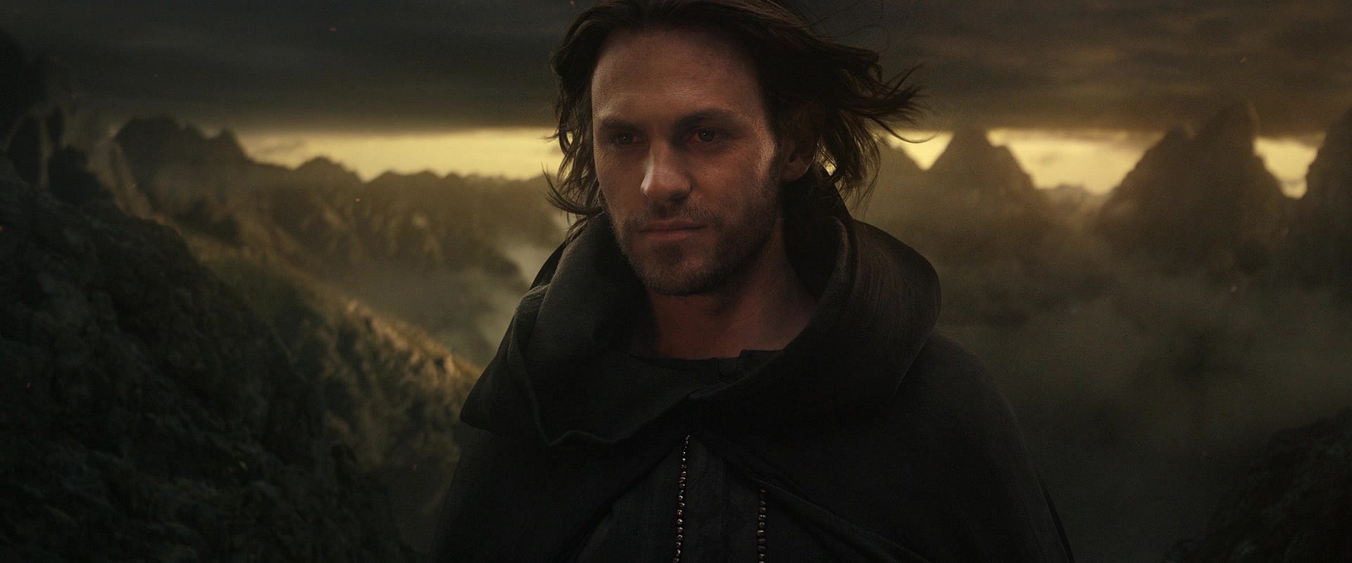 Sauron (Charlie Vickers) stands on the precipice of Mordor in The Lord of the Rings: The Rings of Power Season 1 Episode 8 "Alloyed" (2022), Amazon Studios