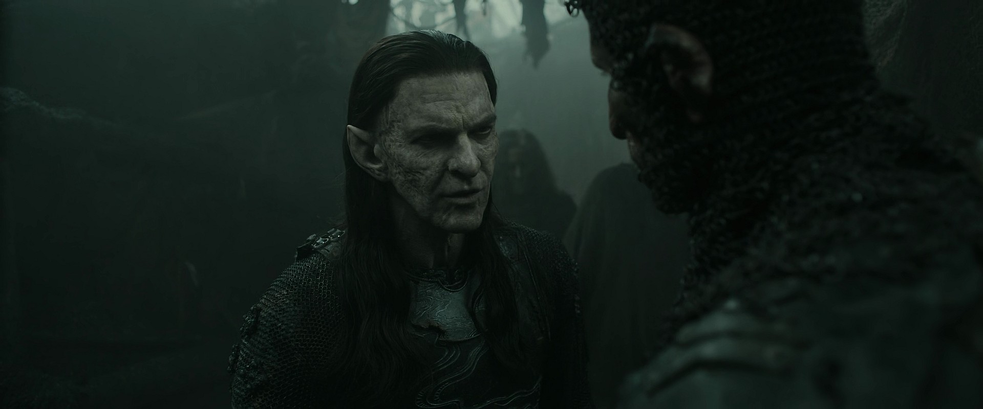 Adar (Joseph Mawle) attempts to reassure Glüg (Robert Strange) of their mission in The Lord of The Rings: The Rings of Power Season 2 Episode 3 " The Eagle and The Sceptre" (2024), Amazon Prime
