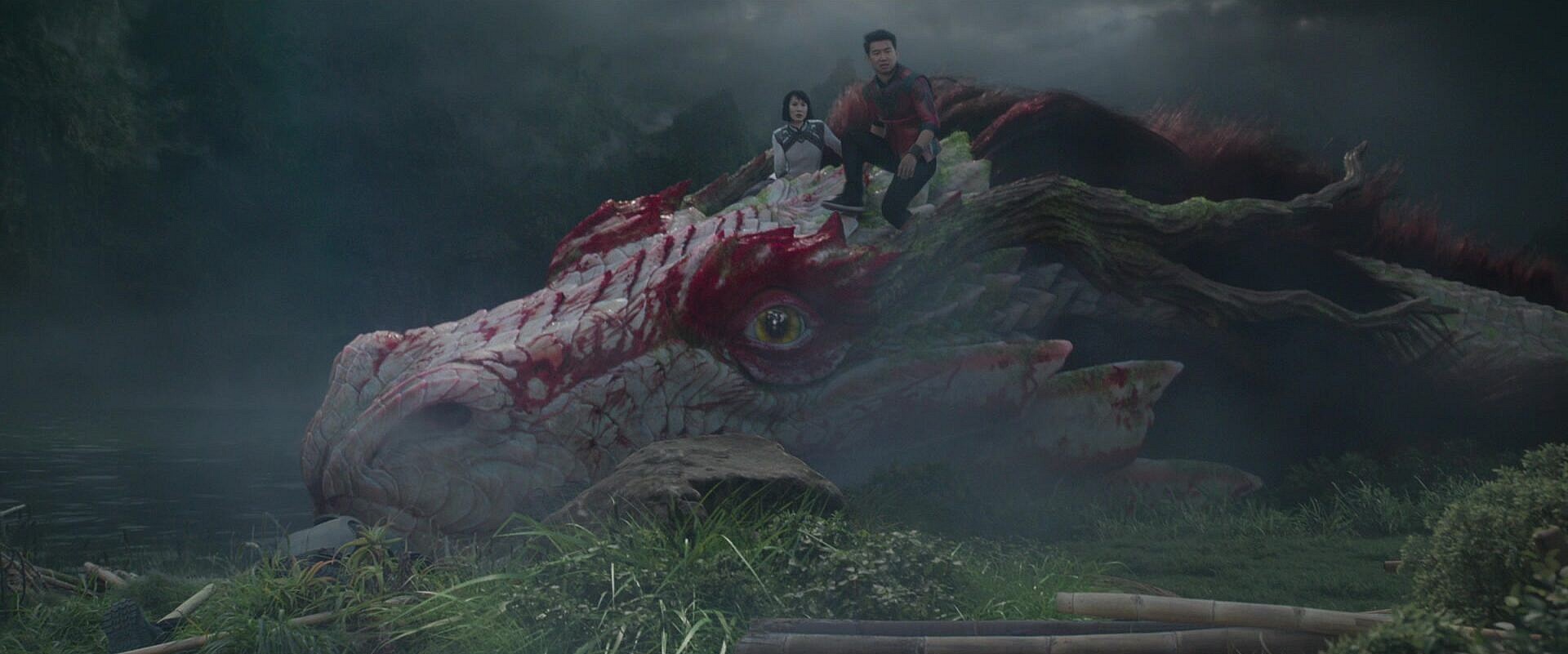 Shang-Chi (Simu Liu) stands triumphant over the Dweller-in-Darkness in Shang-Chi and the Legend of the Ten Rings (2021), Marvel Entertainment