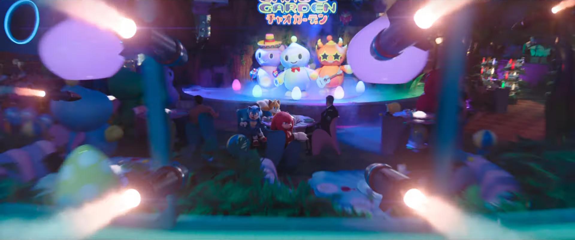 Sonic (Ben Schwartz), Tails (Colleen O'Shaughnessey), and Knuckles (Idris Elba) spy incoming missiles as they sit in the Chao Garden in Sonic the Hedgehog 3 (2024), Paramount Pictures