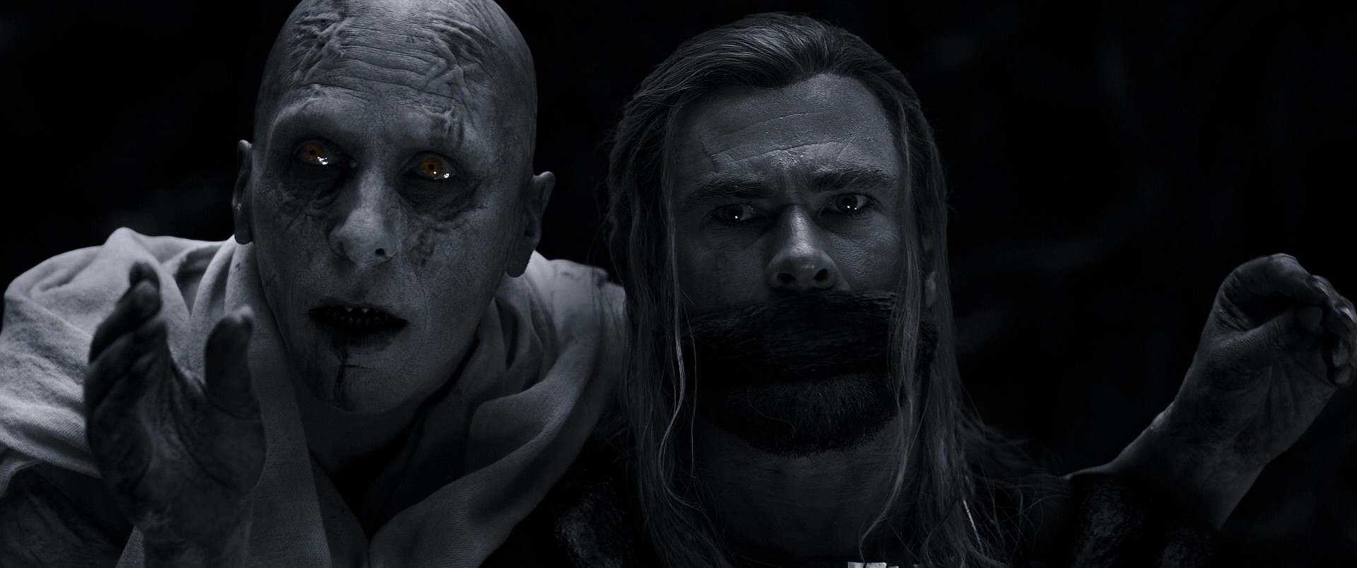Gorr (Christian Bale) has Thor (Chris Hemsworth) in his clutches in Thor: Love and Thunder (2022), Marvel Entertainment