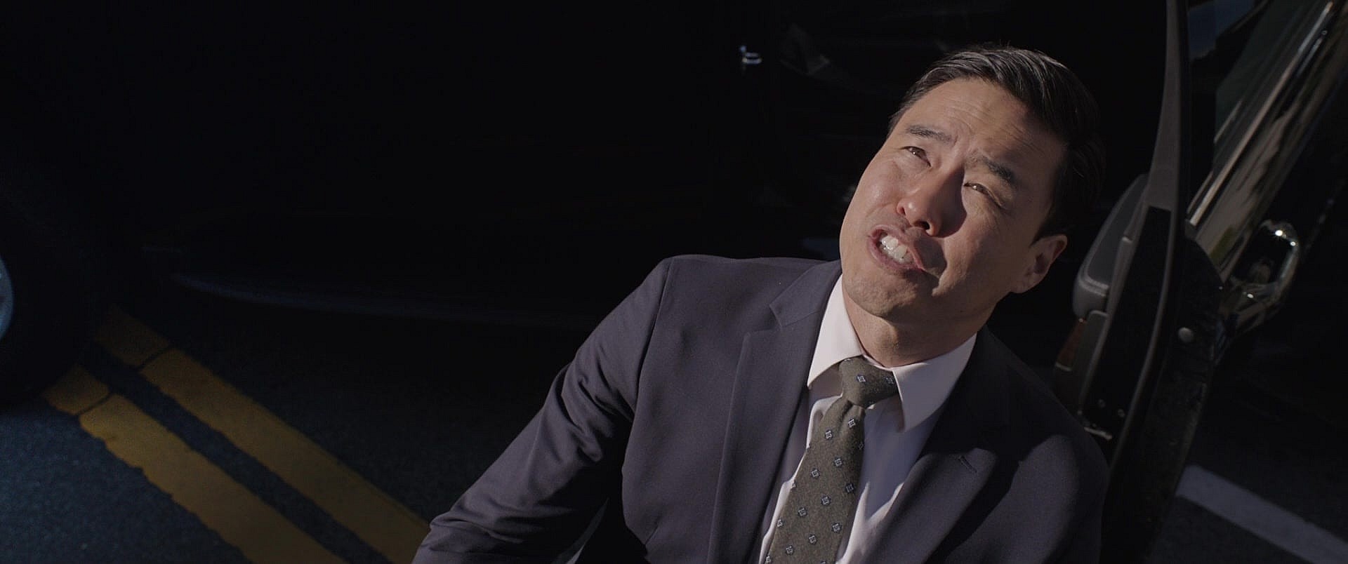 Jimmy Woo (Randall Park) attempts to arrest Scott Lang's (Paul Rudd) empty Giant-Man suit in Ant-Man and the Wasp (2018), Marvel Entertainment