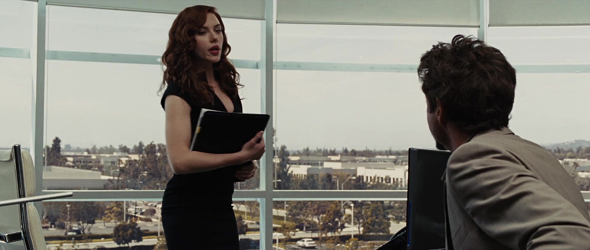 Black Widow (Scarlett Johansson) gives Tony Stark (Robert Downey Jr.) his daily brief in Iron Man 2 (2010), Marvel Entertainment via Blu-ray