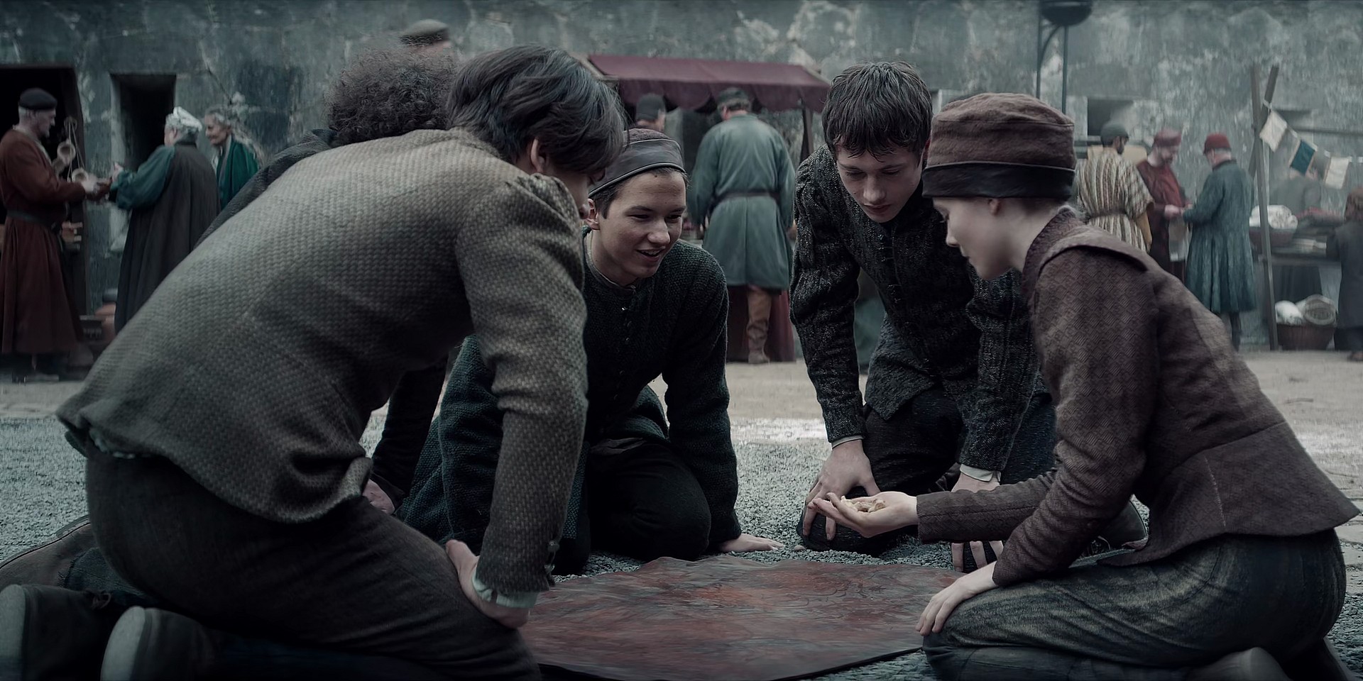 A young Ciri (Freya Allen) plays dice with her friends in The Witcher Season 1 Episode 1 "The End's Beginning" (2019), Netflix