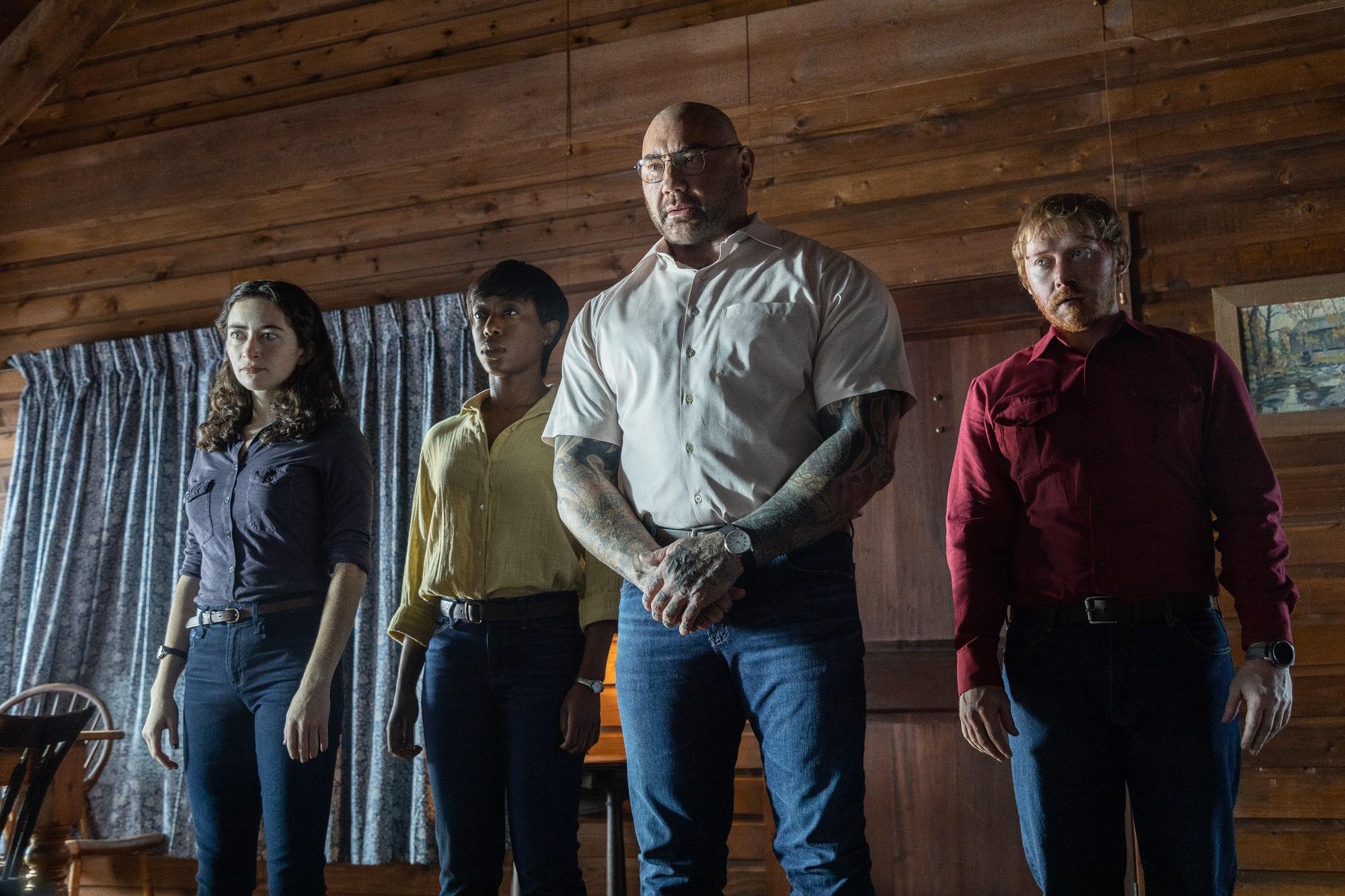 Abby Quinn, Nikki Amuka-Bird, Dave Bautista, and Rupert Grint in M. Night Shyamalan's Knock at the Cabin. Property of Universal Pictures.