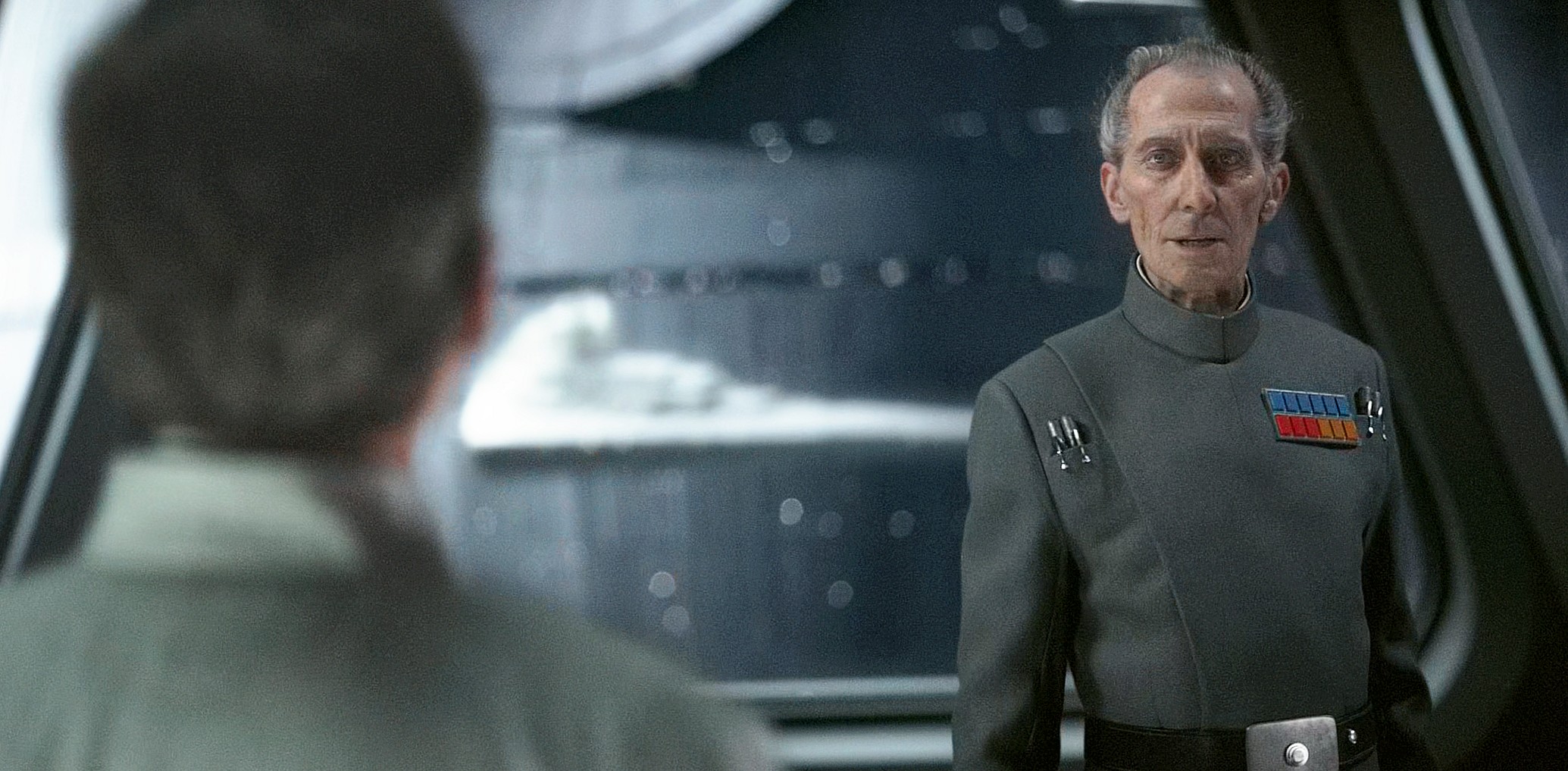 Grand Moff Tarkin (Peter Cushing) has new orders for Director Krennic (Ben Mendelsohn) in Rogue One: A Star Wars Story (2016), Disney