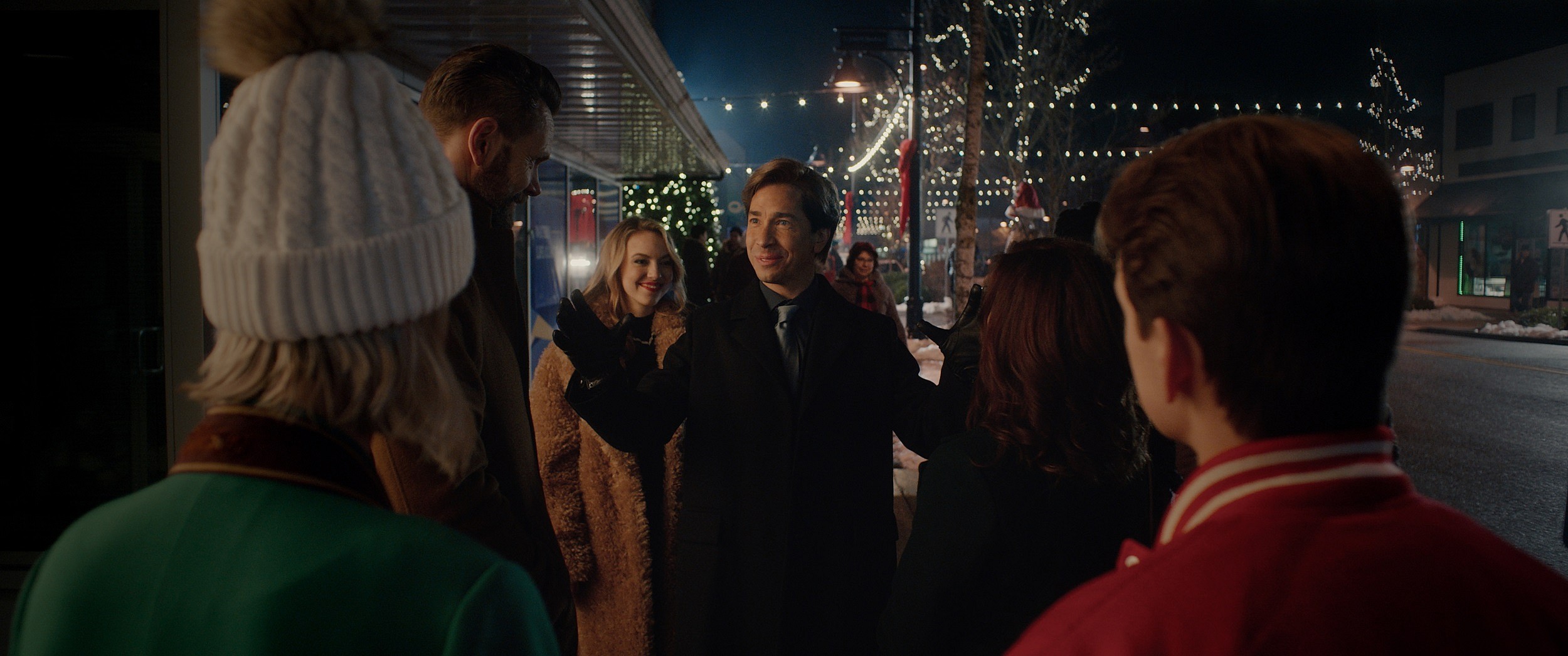 Mayor Henry Waters (Justin Long) is reluctantly greeted by the Carruthers family during the holidays in the horror comedy It's a Wonderful Knife.
Image property of RLJE Films and Shudder.