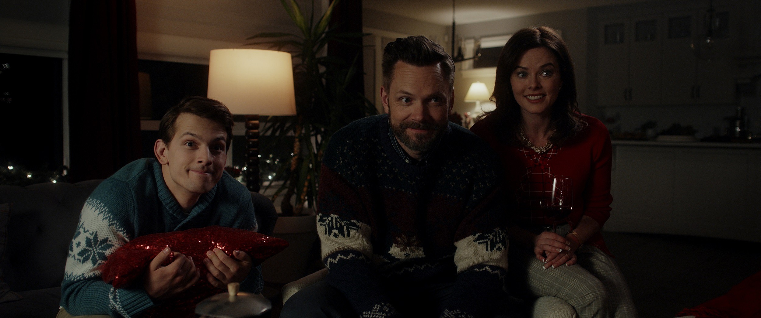(From L to R) The Carruthers family: Winnie's brother Jimmy (Aiden Howard), their father David (Joel McHale), and mother Judy (Erin Boyes).
Image property of RLJE Films and Shudder.