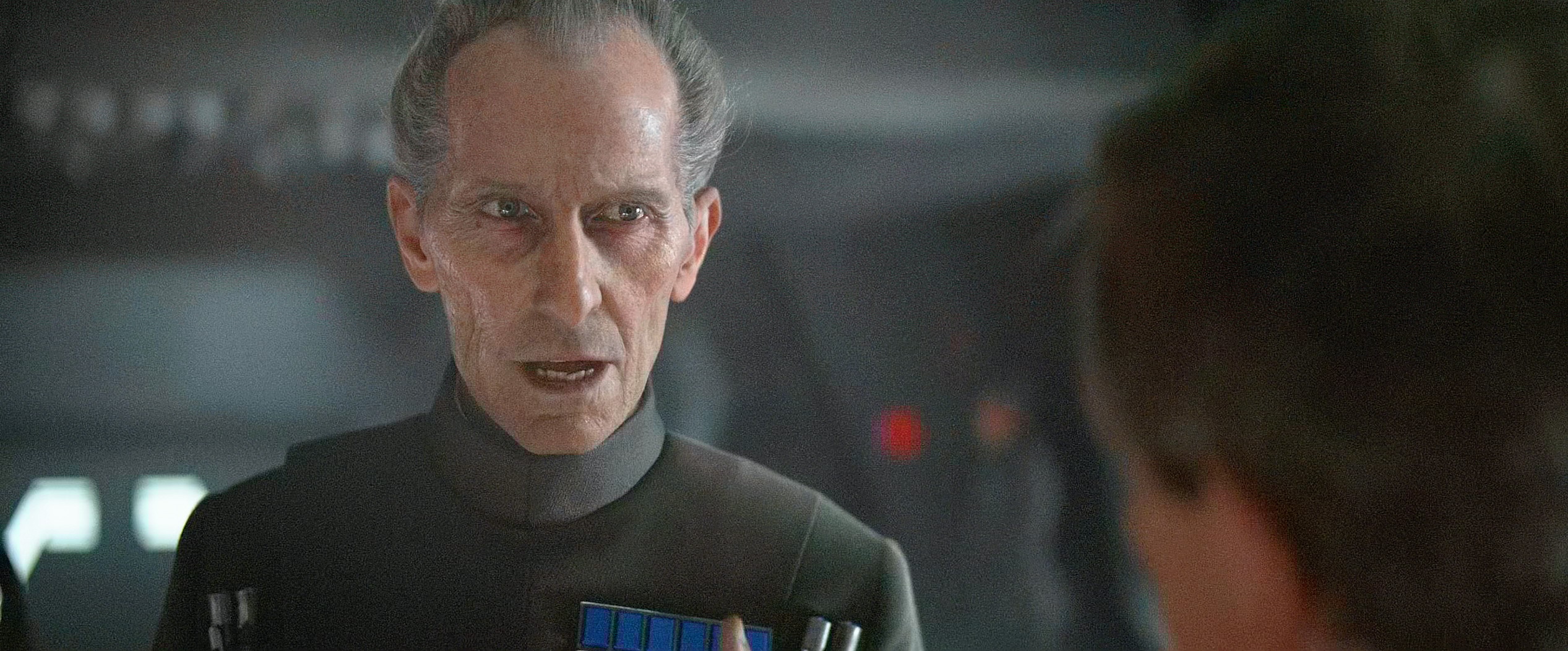 Grand Moff Tarkin (Peter Cushing) demands results from Director Krennic (Ben Mendelsohn) in Rogue One: A Star Wars Story (2016), Disney