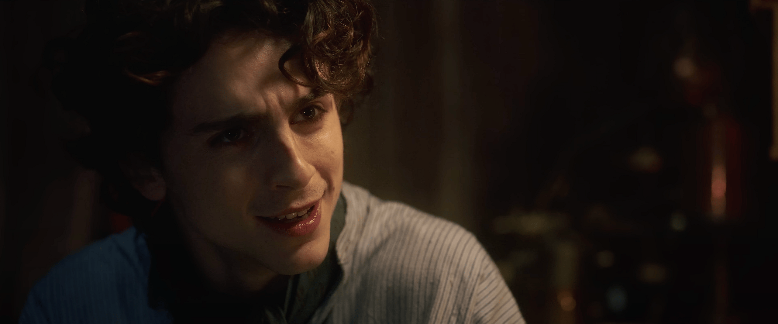 Willy Wonka (Timothée Chalamet) is first introduced to an Oompa Loompa (Hugh Grant) in Wonka (2023), Warner Bros. Pictures