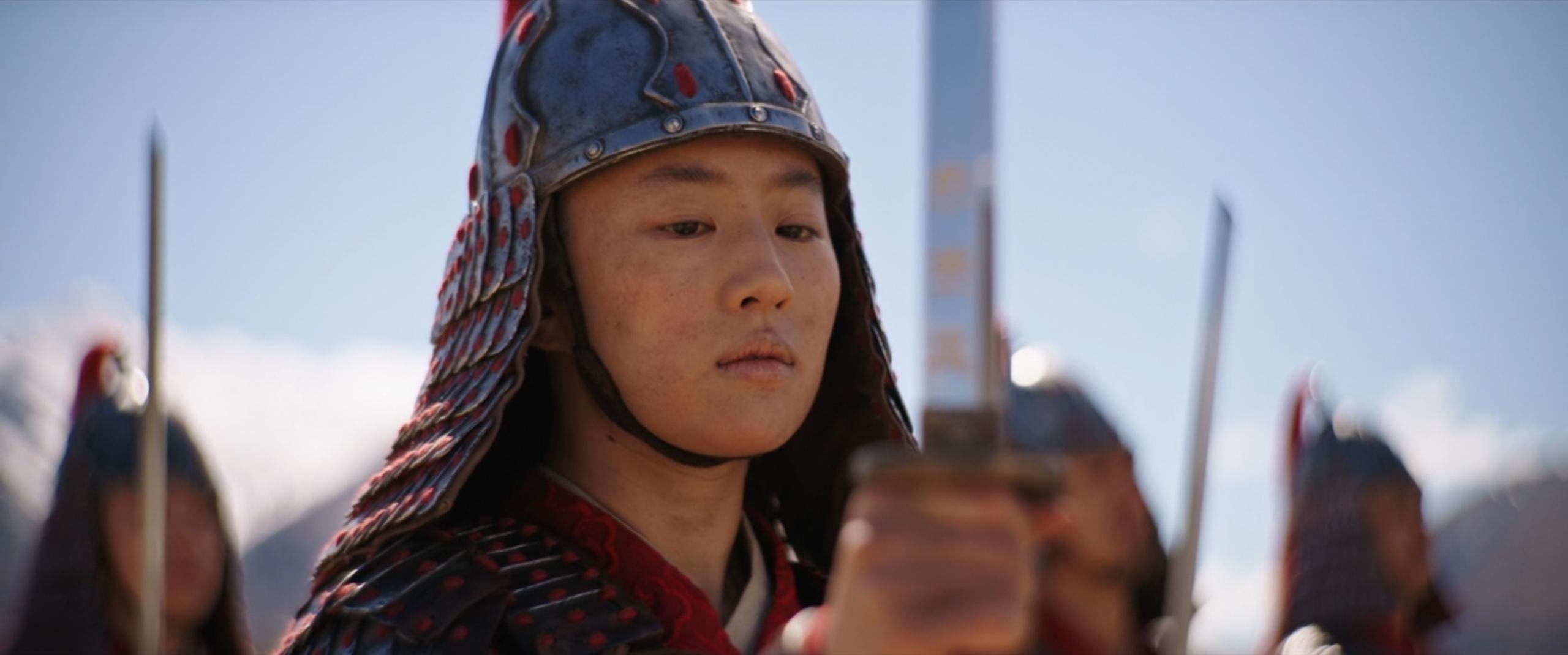 Mulan (Liu Yifei) hesitates as she takes the oath of the warrior in Mulan (2020), Walt Disney Studios Motion Pictures
