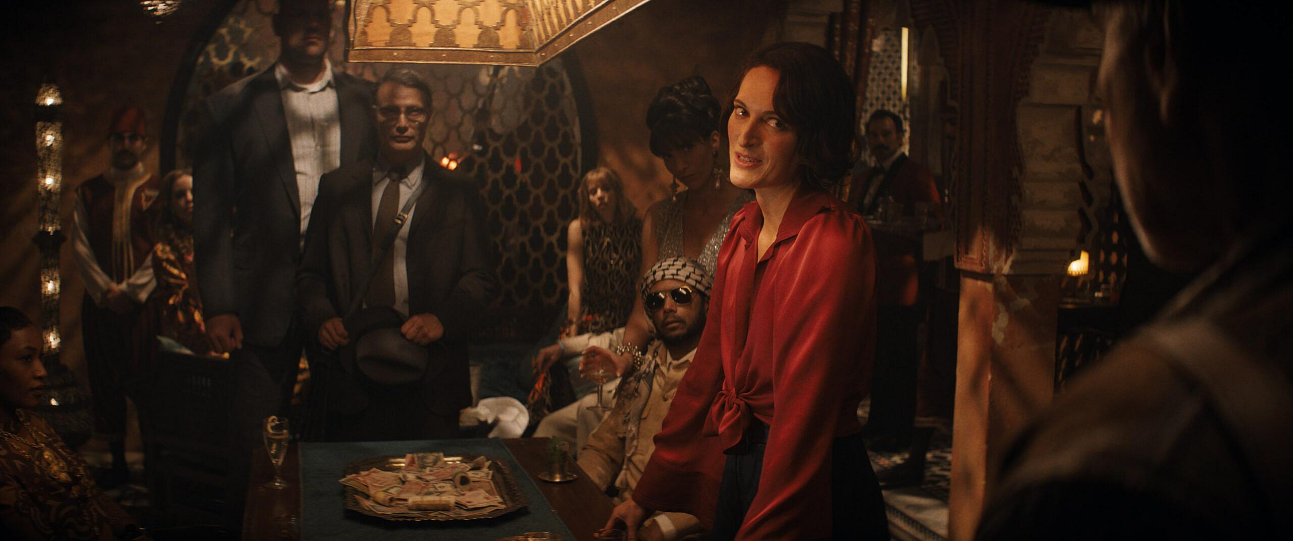Mads Mikkelsen as Doctor Jürgen Voller, Phoebe Waller-Bridge as Helena, and Harrison Ford as