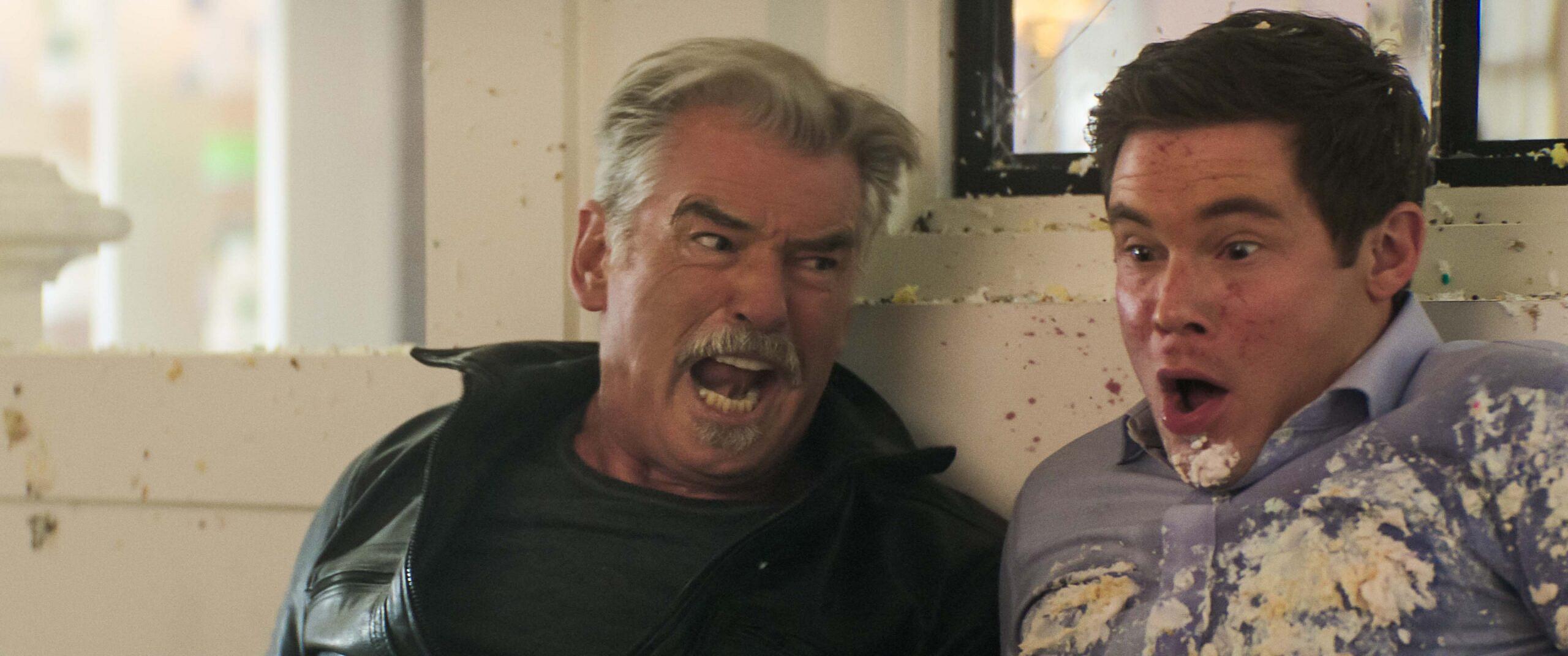 Pierce Brosnan as Billy McDermott and Adam DeVine as Owen Browning in The Out-Laws, Netflix
