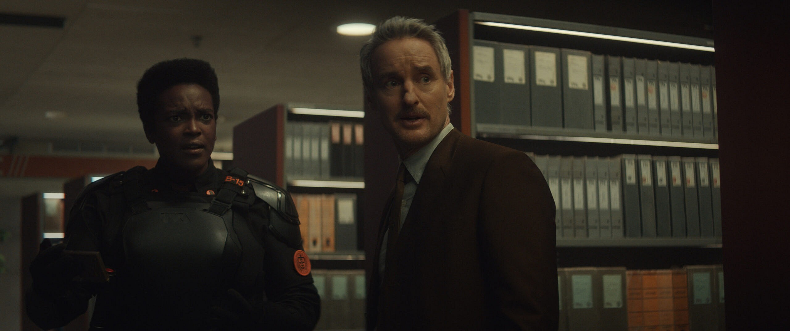 (L-R): Hunter B-15 (Wunmi Mosaku) and Mobius (Owen Wilson) in Marvel Studios' LOKI, exclusively on Disney+. Photo courtesy of Marvel Studios. ©Marvel Studios 2021. All Rights Reserved.