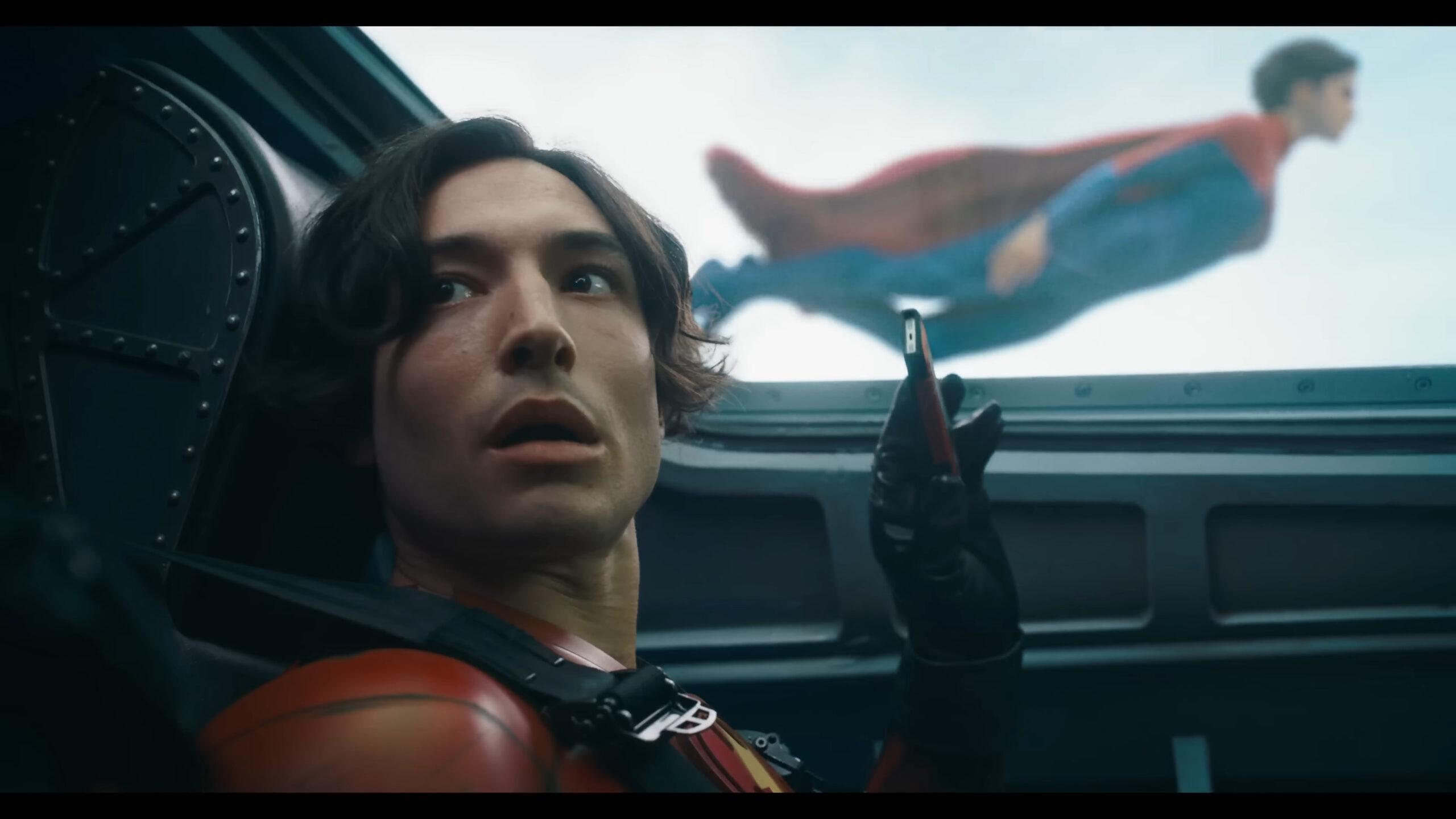 Barry Allen (Ezra Miller) tries to capture a video of Supergirl (Sasha Calle) in Barry Allen as the Flash in The Flash (2023), Warner Bros. Pictures