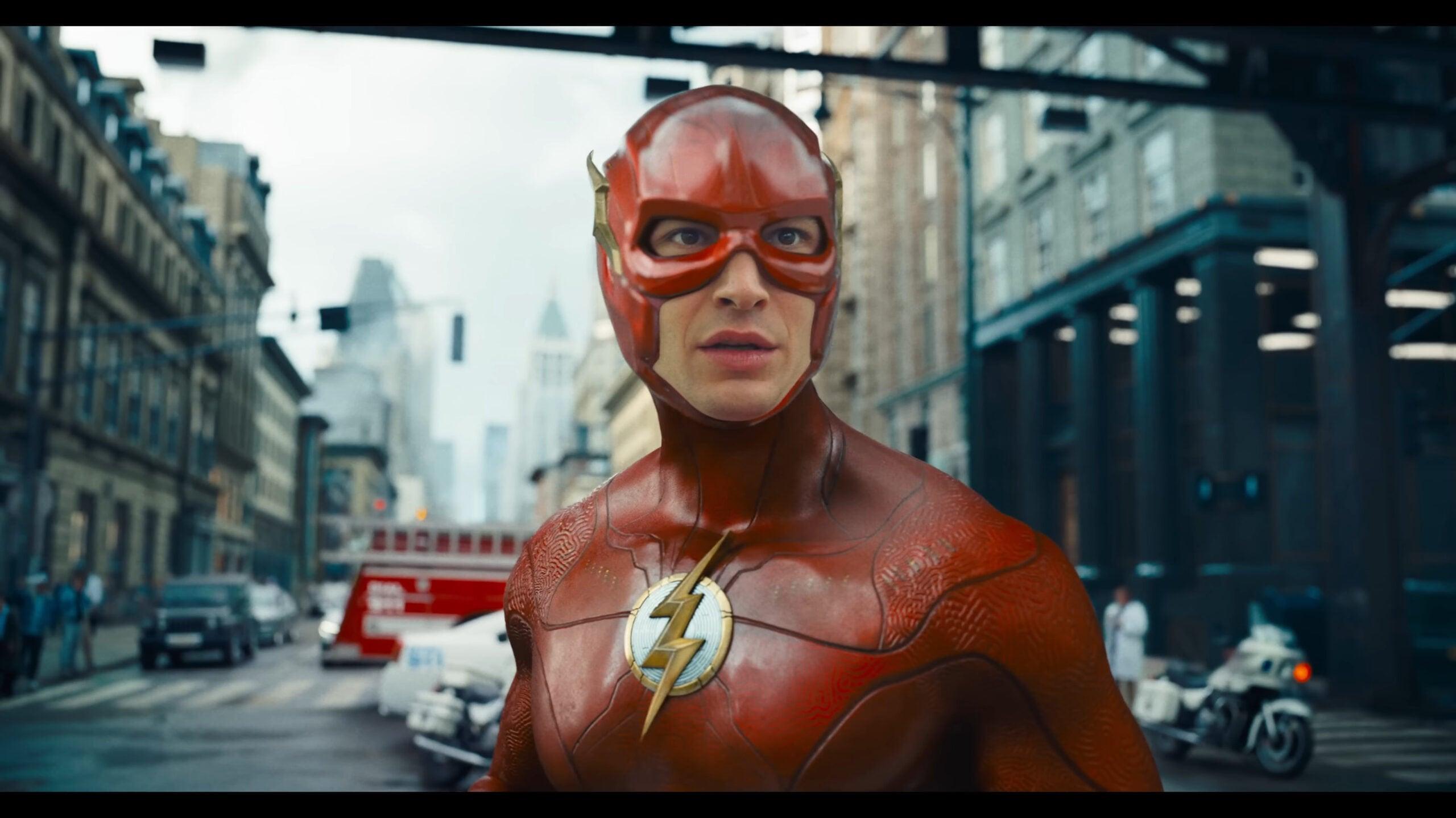 Barry Allen (Ezra Miller) prepares to confront Zod (Michael Shannon) on the streets of Metropolis in Batman (Michael Keaton) reveals his cache of Batsuits in The Flash (2023), Warner Bros. Pictures