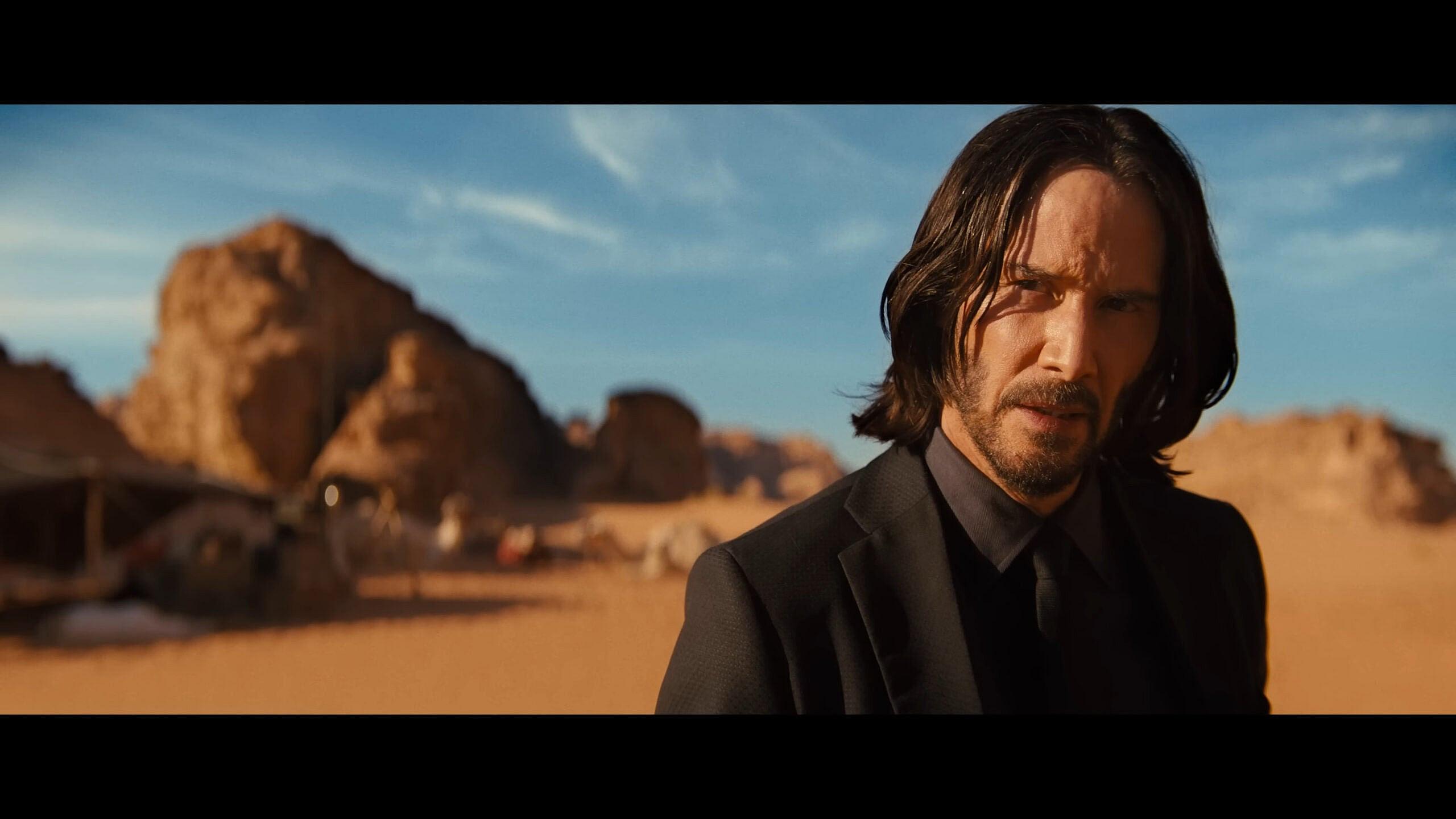 John Wick (Keanu Reeves) questions Elder (George Georgiou) in John Wick: Chapter 4 (2023)