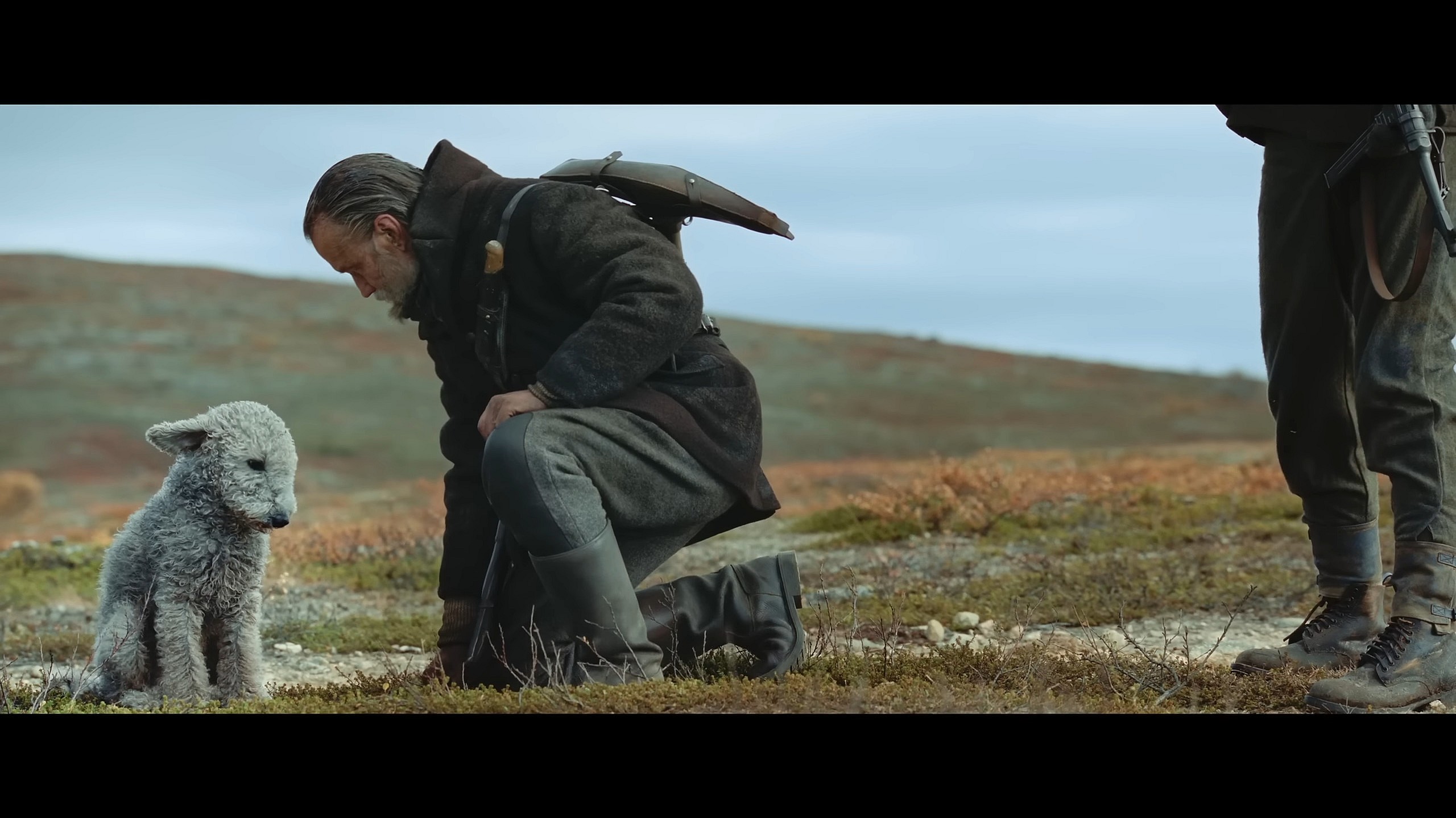 Aatami (Jorma Tommila) invites his dog to sit out the upcoming fight in Sisu (2023), Lionsgate