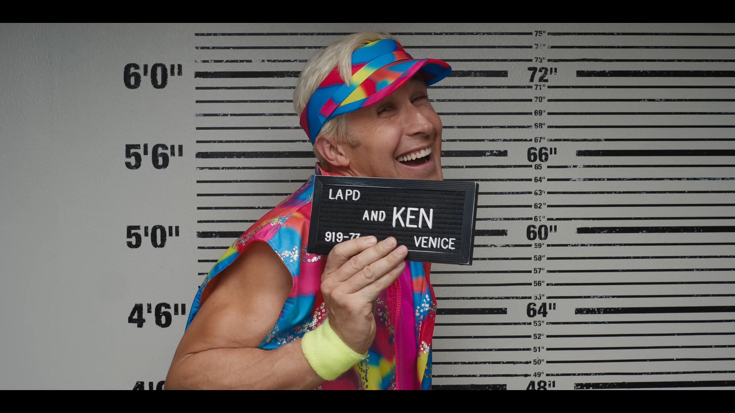Ken (Ryan Gosling) takes his mugshot in Barbie (2023), Warner Bros. Pictures
