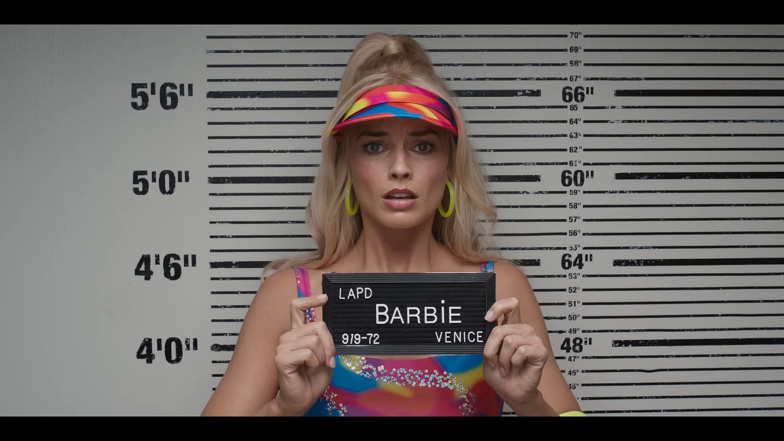 Barbie (Margot Robbie) is arrested in Los Angeles n in Barbie (2023), Warner Bros. Pictures