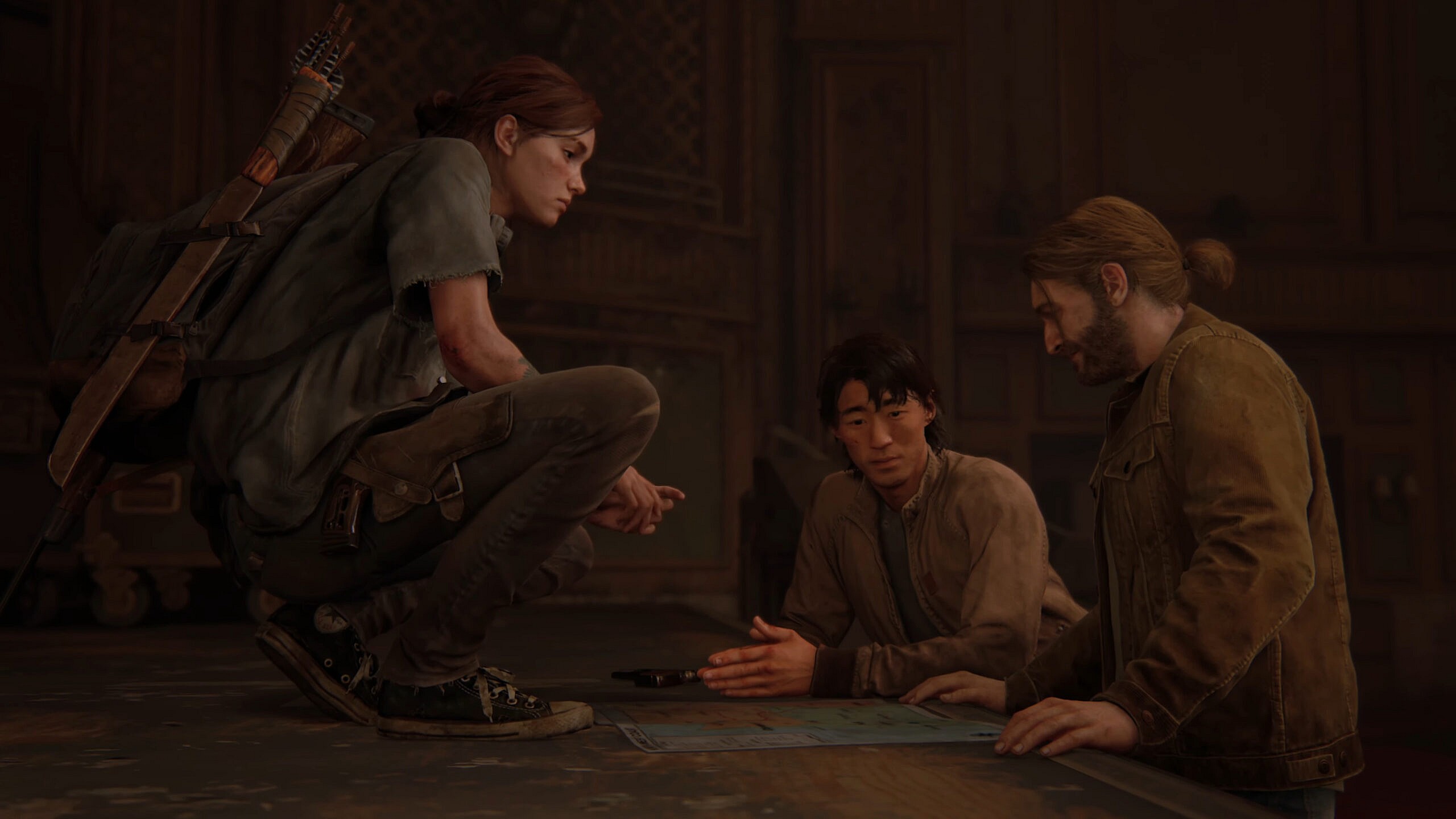 Ellie (Ashley Johnson), Jesse (Stephen Chang) and Tommy (Jeffrey Pierce) map out their next move in The Last of Us Part II (2020), Naughty Dog