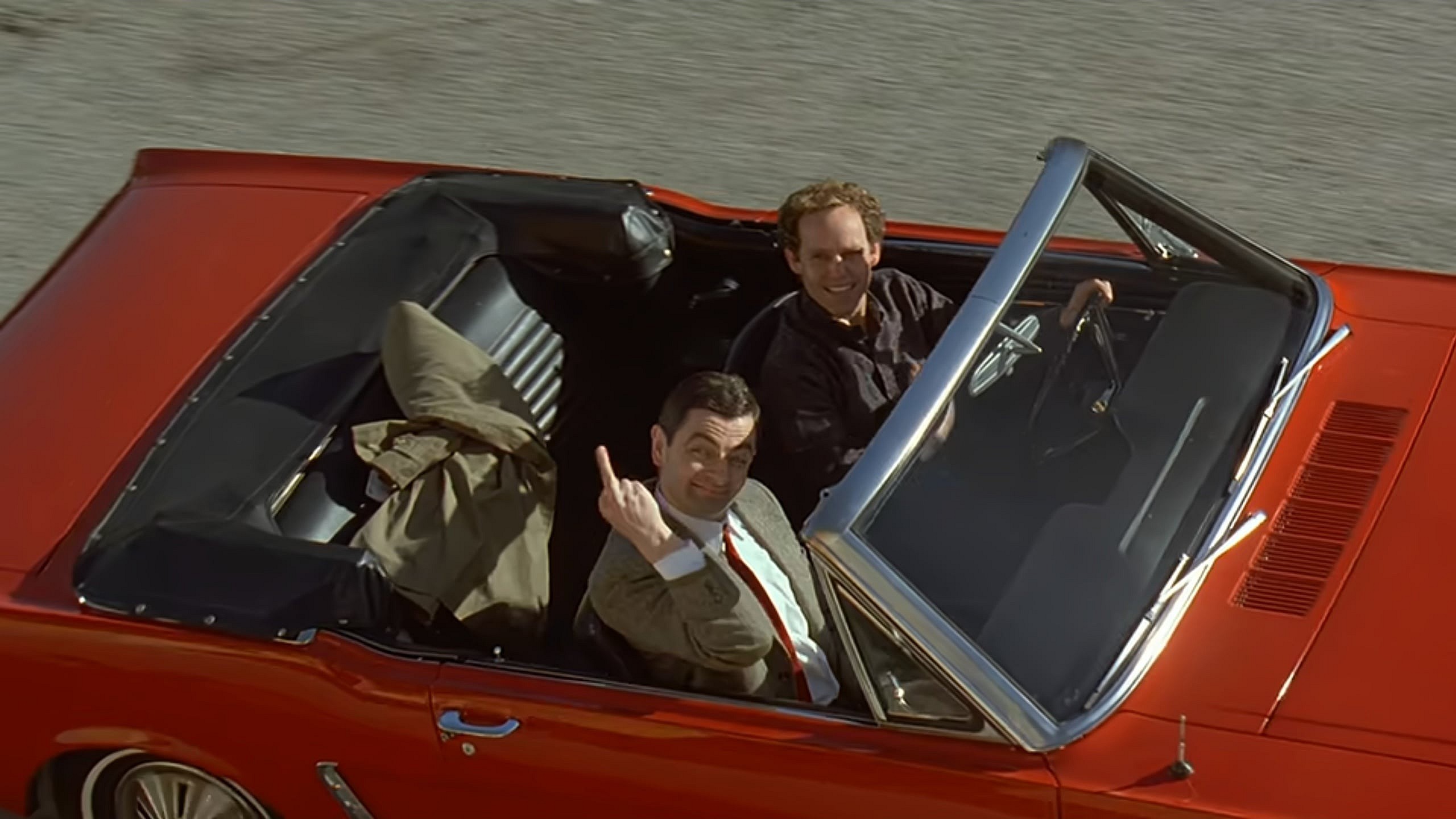 Mr. Bean (Rowan Atkinson) bids David Langley's (Peter MacNicol) family farewell in Bean: The Ultimate Disaster Movie (1997), Tiger Aspect Films