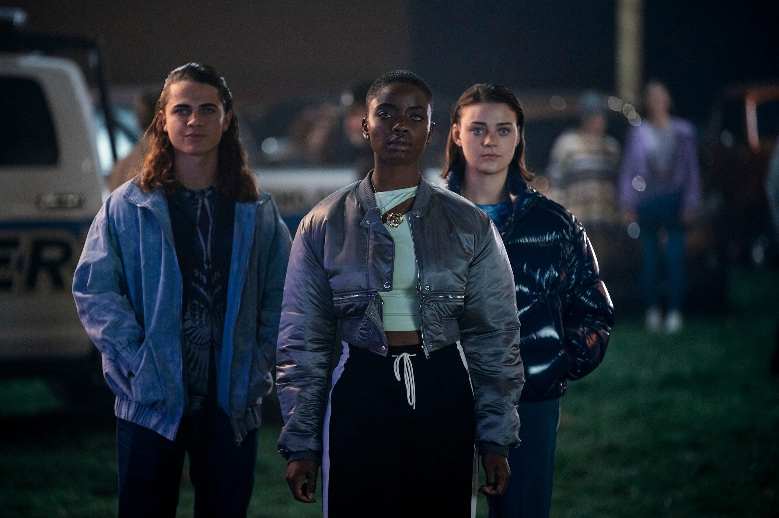 Wednesday. (L to R) Oliver Watson as Kent, Joy Sunday as Bianca Barclay, Johnna Dias-Watson as Divina in episode 101 of Wednesday. Cr. Vlad Cioplea/Netflix © 2022