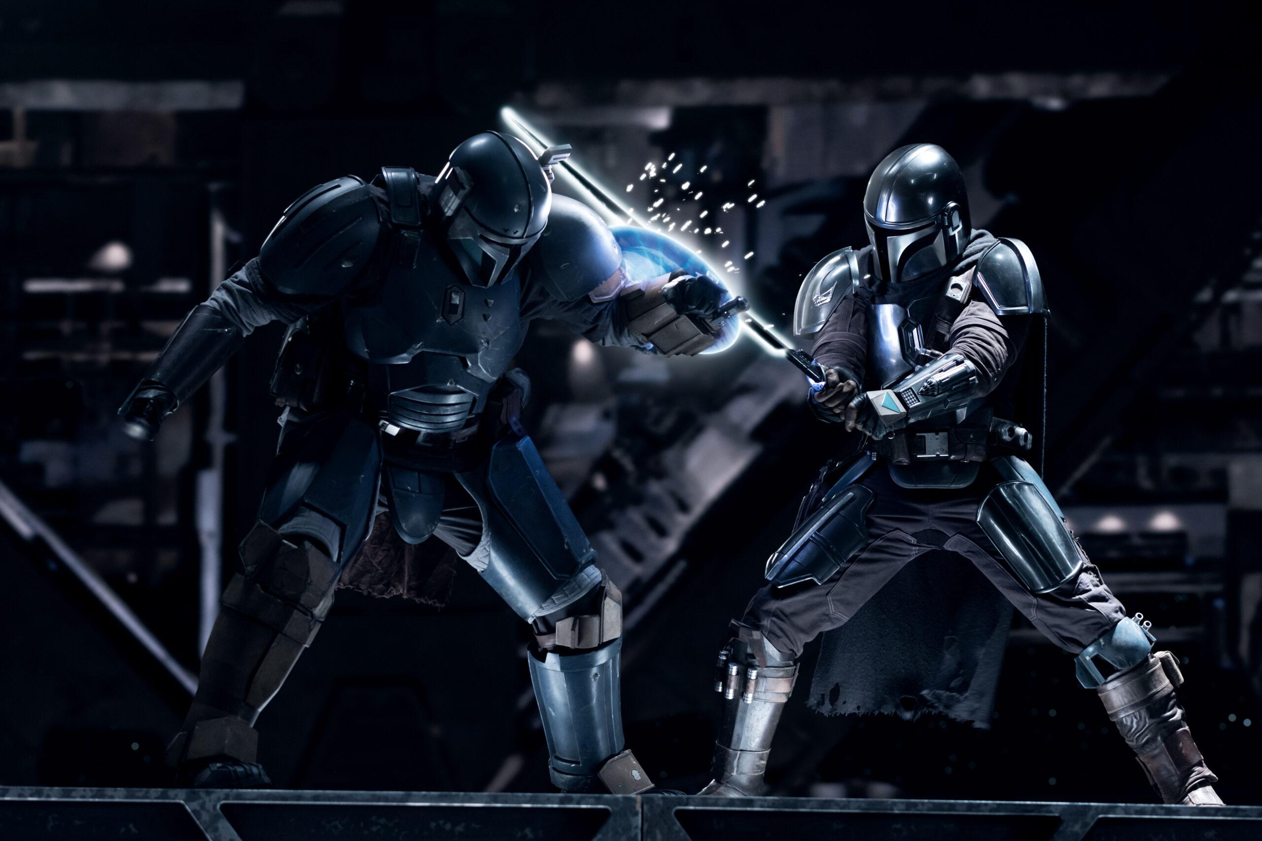 (L-R): Paz Vizsla and the Mandalorian (Pedro Pascal) in Lucasfilm's THE BOOK OF BOBA FETT, exclusively on Disney+. © 2022 Lucasfilm Ltd. & ™. All Rights Reserved.