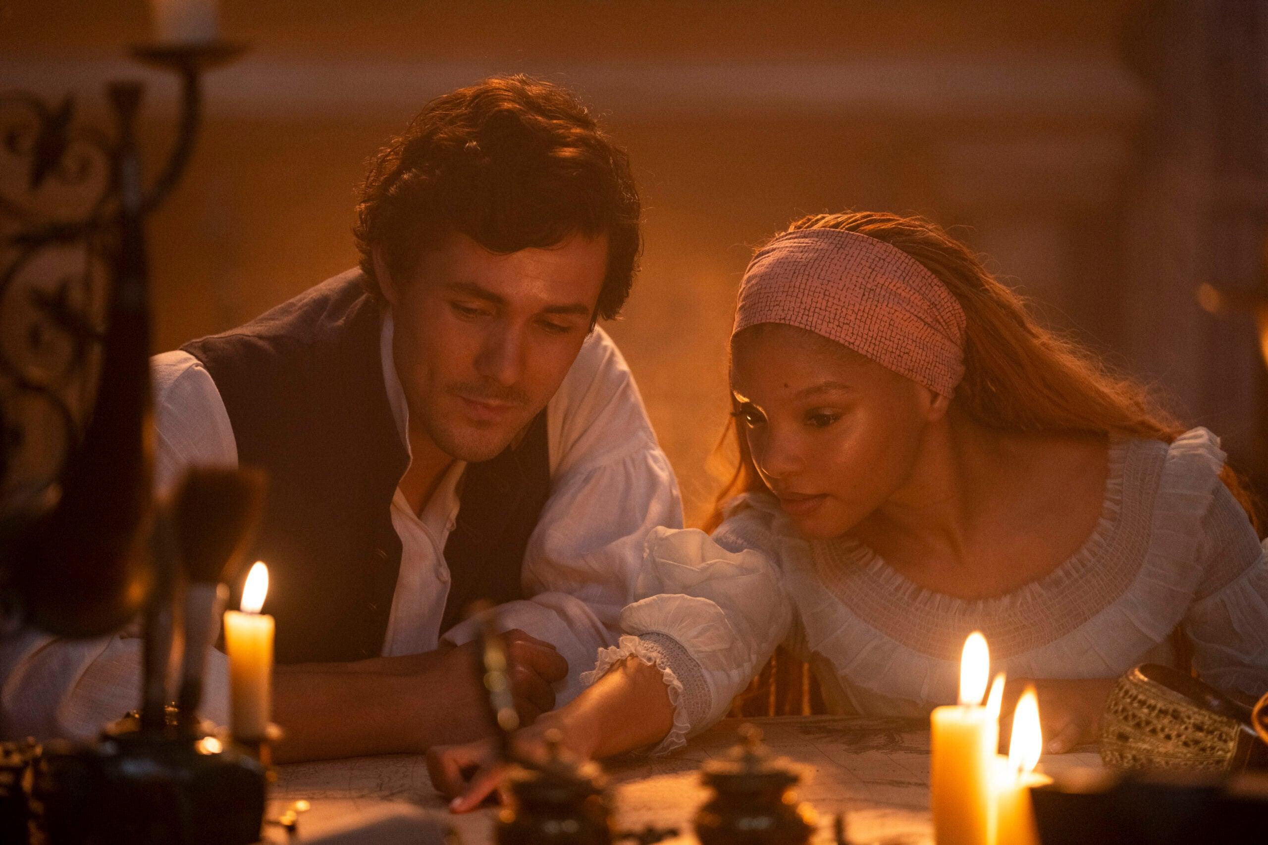 (L-R): Jonah Hauer-King as Prince Eric and Halle Bailey as Ariel in Disney's live-action THE LITTLE MERMAID. Photo by Giles Keyte. © 2023 Disney Enterprises, Inc. All Rights Reserved.