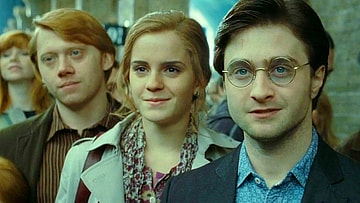 Ron (Rubert Gint), Hermoine (Emma Watson), and Harry (Daniel Radcliffe) see their children off to Hogwarts in Harry Potter and the Deathly Hallows - Part 2 (2010), Warner Bros. Pictures