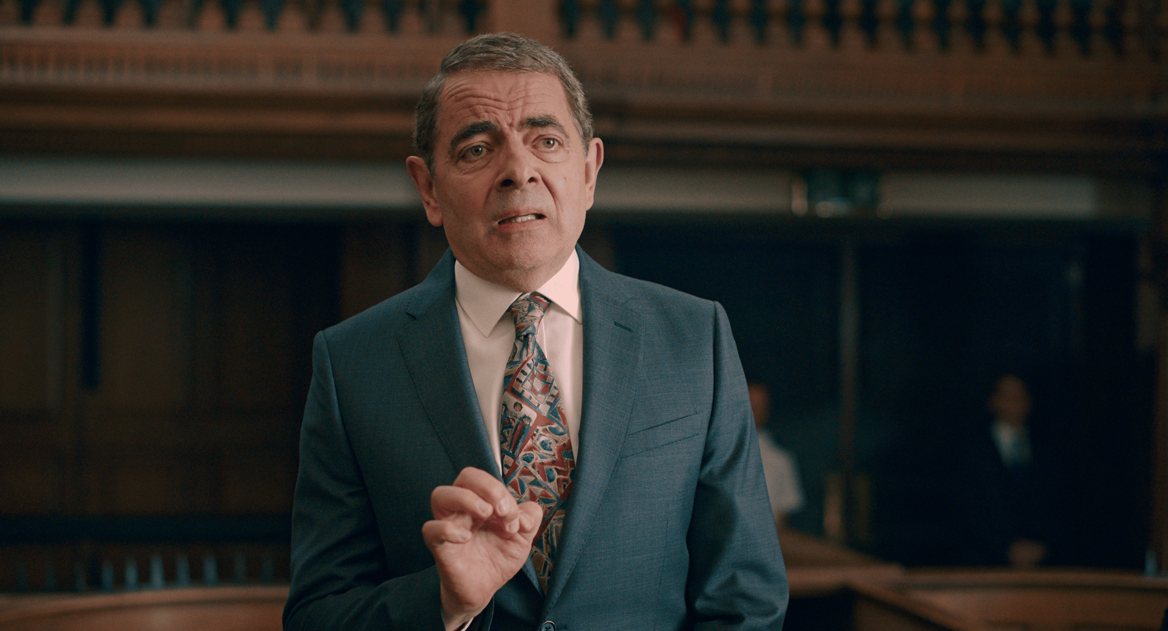House sitter Trevor Bingley (Rowan Atkinson) attempts to explain his actions in court in Man vs. Bee Season 1 Episode 1 "Chapter 1" (2022), Netflix
