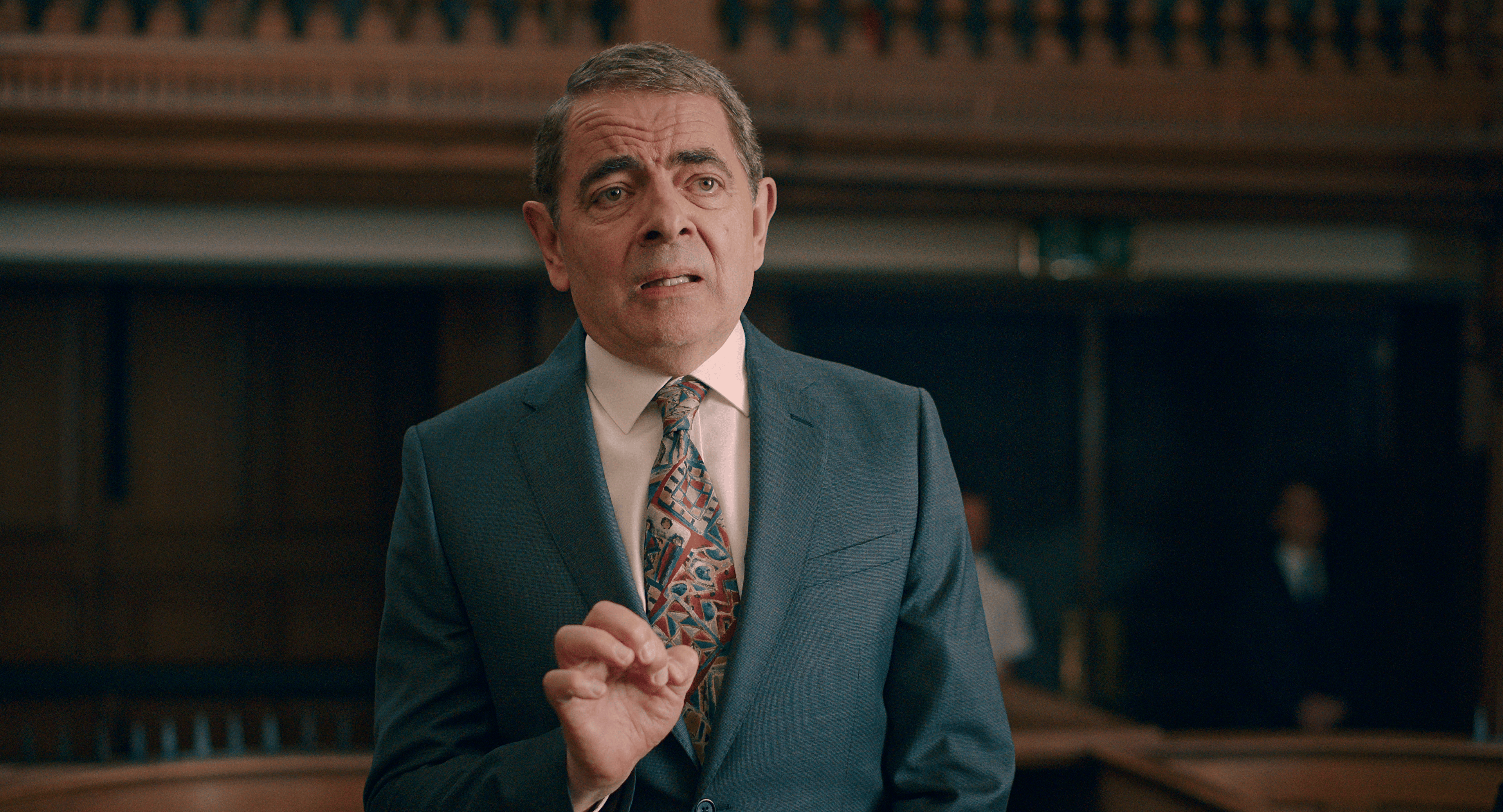 House sitter Trevor Bingley (Rowan Atkinson) attempts to explain his actions in court in Man vs. Bee Season 1 Episode 1 "Chapter 1" (2022), Netflix