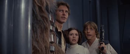 Chewbacca (Peter Mayhew), Han Solo (Harrison Ford), Princess Leia Organa (Carrie Fisher), and Luke Skywalker (Mark Hamill) plan their escape from the Death Star in Star Wars Episode IV: A New Hope (1977), Lucasfilm