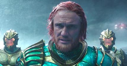 King Nereus (Dolph Lundgren) patiently watches as the battle between Aquaman (Jason Momoa) and Ocean Master (Patrick Wilson) unfolds in Aquaman (2018), Warner Bros. Pictures