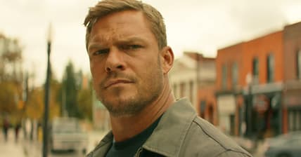 Jack (Alan Ritchson) takes notice of a less-than-savory character in Reacher Season 2 Episode 1 "ATM" (2023), Amazon