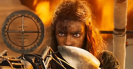 Furiosa takes aim with a harpoon gun in Furiosa: A Mad Max Saga (2024)