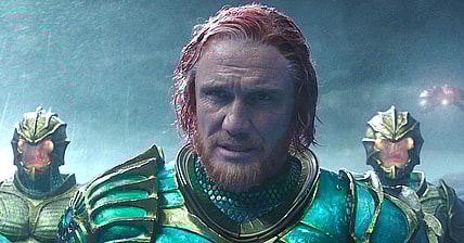 King Nereus (Dolph Lundgren) patiently watches as the battle between Aquaman (Jason Momoa) and Ocean Master (Patrick Wilson) unfolds in Aquaman (2018), Warner Bros. Pictures