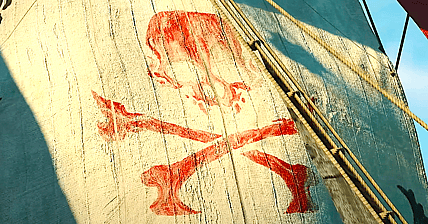 A pirate flag flapping in the wind in Skull & Bones (2024), Ubisoft