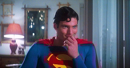 Superman (Christopher Reeve) is amused by something Lois (Margot Kidder) asks in Superman: The Movie (1978), Warner Bros. Pictures
