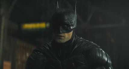Batman (Robert Pattinson) reveals himself to a gang attempting a robbery in The Batman (2022), Warner Bros. Pictures