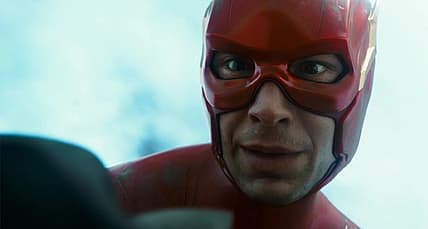 Flash (Ezra Miller) holds dying Batman (Michael Keaton) in The Flash (2023), Warner Bros