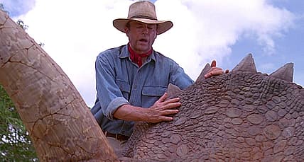Dr. Alan Grant (Sam Neill) touches a dinosaur in Jurassic Park (1993), Universal Pictures
