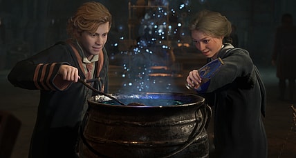 A Griffindor and Ravenclaw student brew a potion in a cauldron, as blue sparks float up from it via Hogwarts Legacy (2023), Warner Bros. Interactive Entertainment