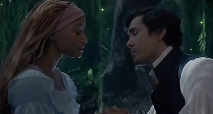Prince Eric (Jonah Hauer-King) moves in to kiss Ariel (Halle Bailey) in The Little Mermaid (2023), Disney